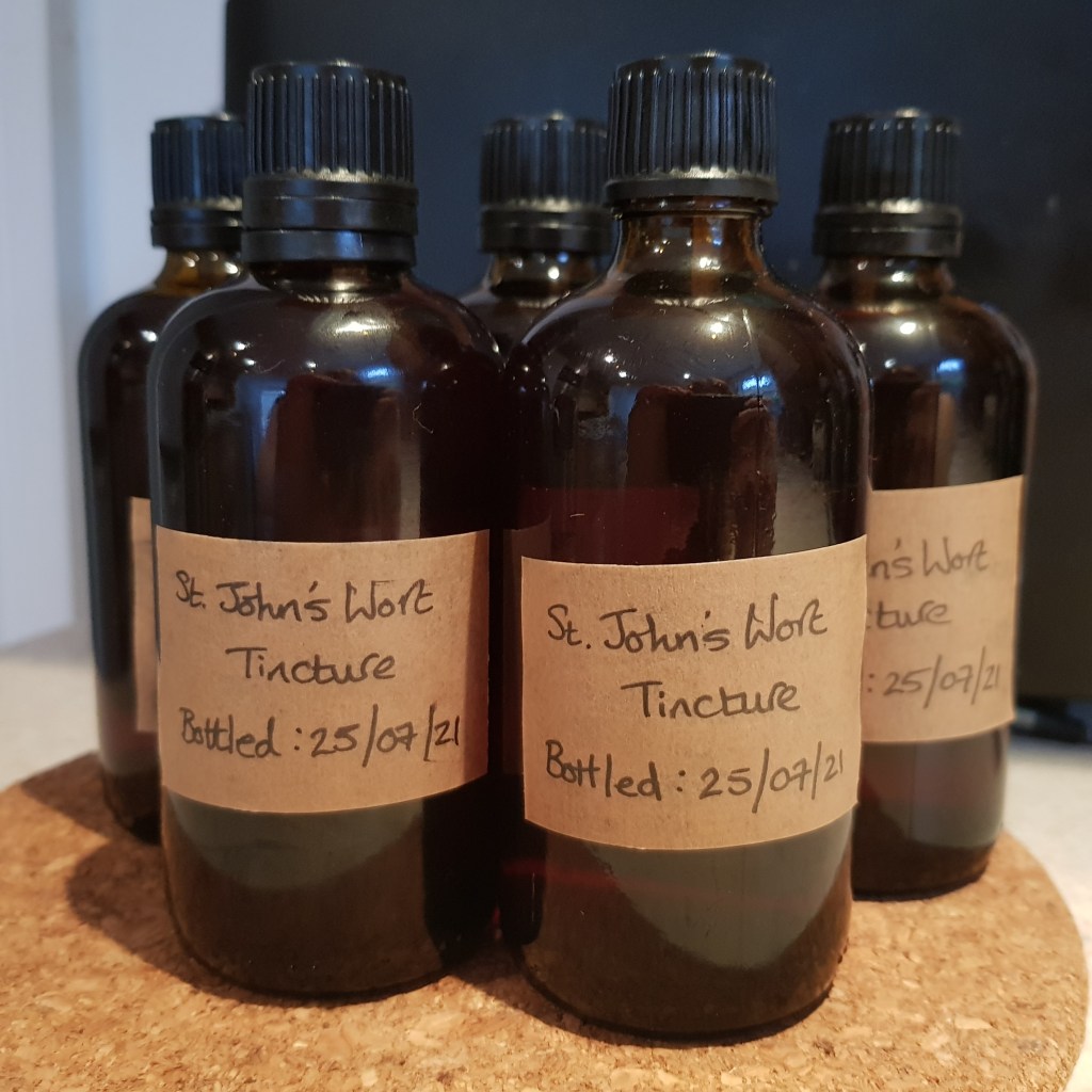 St. John's Wort tincture in amber bottles, labelled by hand